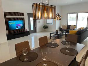 a living room with a table with wine glasses on it at Bubali Modern Suites Aruba in Palm-Eagle Beach