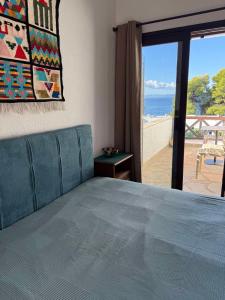 a bedroom with a bed and a view of the beach at Elia Sea View Apartments 2 in Elia