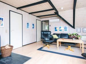 a living room with a couch and a table at 4 star holiday home in Rømø in Kongsmark