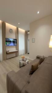 a living room with a couch and a tv at MK Luxury Serviced Apartments #3 in Chişinău
