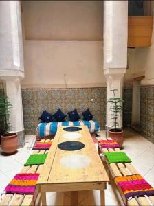 a large table and chairs in a room at Riad Ayoub Fes in Fès