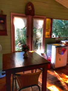 a kitchen with a wooden table and a refrigerator at Cabaña - Shaby in Tigre