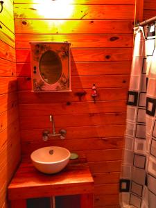 a wooden bathroom with a sink and a mirror at Cabaña - Shaby in Tigre
