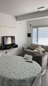 a living room with a table and a couch at Sol y olas in Playa Unión