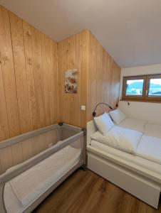a small bedroom with a bed and a window at Ferienwohnung Goasnstoi - mit HotTub und Bergblick im Inntal in Flintsbach am Inn