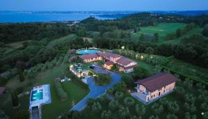 an aerial view of a house with a swimming pool at Garda Hill Boutique Apartments with Panoramic Pools e Agriturismo in Soiano del Lago +45 photos