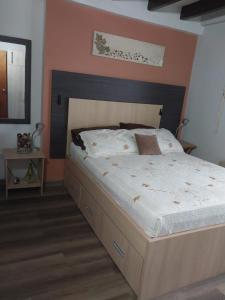 a bedroom with a large bed with a wooden headboard at Bahía Fragata 204 in San Andrés +4 photos
