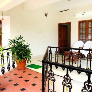 a staircase in a house with a potted plant at Aromal Homestay in Kovalam