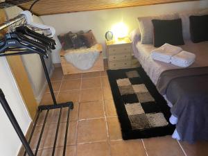 a bedroom with a bed and a dresser with a lamp at MG Guest Room in Alcossebre +9 photos