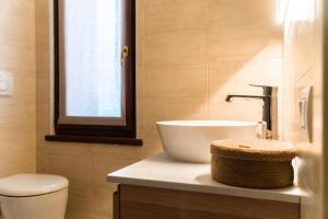 a bathroom with a sink and a toilet at Maison Poluc - Suite Alpine in Champoluc