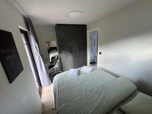 a bedroom with a bed with two white towels on it at Chalet Orkanger - Close to Everything, Far from Ordinary in Orkanger