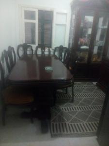 a dining room with a wooden table and chairs at Safari home in Petra