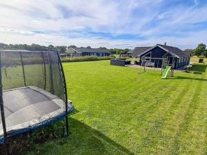 a playground with a trampoline in a yard at Luxury Lakeside Retreat - By Traum Ferienwohnungen in Ansager