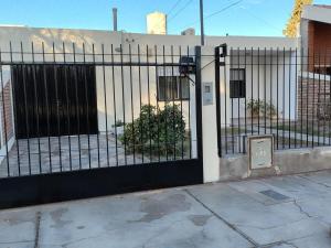 a black fence with a gate in front of a building at Casa El Jacarandá in San Juan