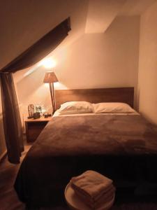 a bedroom with a bed with a lamp and towels on it at Sobe za odmor Sandra in Donja Stubica +17 photos