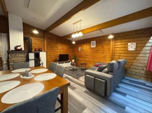 a living room with a table and chairs and a couch at Madeira Haus in Starzach