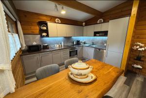 a kitchen with a wooden table with a bowl on it at Madeira Haus in Starzach
