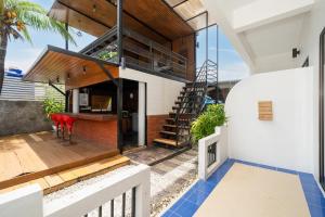 a house with a view of the kitchen and living room at JR Siam Inn Resort in Kata Beach