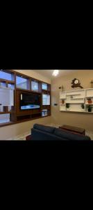 a living room with a blue couch and a flat screen tv at Misty cloud homestay in Pīrmed