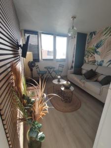 a living room with a couch and a table at STUDIO à SAINT-DENIS DE LA REUNION in Saint-Denis