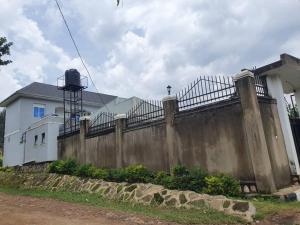 a fence in front of a house with a water meter at UZIMA HOMEs in Fort Portal
