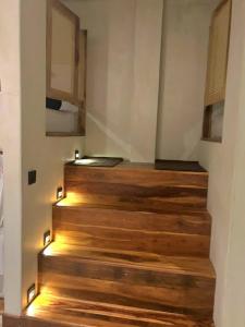 a staircase with wooden floors and a room with a bed at Casa Carmen Hostel in Weligama