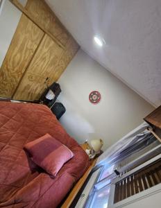 a small room with a bed in a attic at Casa equipada y acogedora in Trinidad