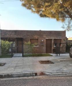 a brick building with two doors and a fence at Casa equipada y acogedora in Trinidad