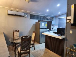a kitchen with a table and chairs and a refrigerator at Townhouse in Siguatepeque +2 photos
