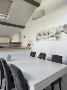 a white dining room with a white table and chairs at Appartement- cœur de Cannes in Cannes