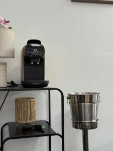 a toaster sitting on a table next to a bucket at Appartement- cœur de Cannes in Cannes +10 photos