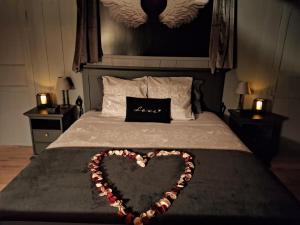 a heart decoration on a bed in a bedroom at L' Antre de L' Ange in Trédarzec +21 photos
