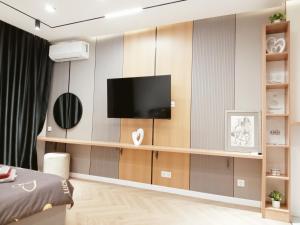 a living room with a tv on a wall at Комфортная квартира в центре города in Almaty