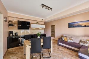 a living room with a couch and a table at Four Seasons Aquamarina in Świnoujście