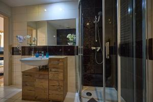 a bathroom with a sink and a shower at Four Seasons Aquamarina in Świnoujście +23 photos