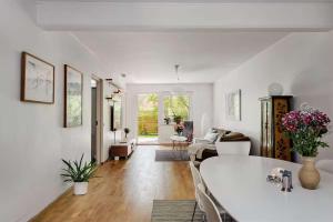 a living room with a white table and a couch at Spacious Apartment in Sodermalm in Stockholm +8 photos