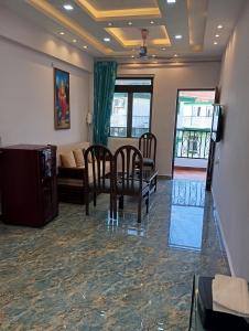 a living room with a couch and a table and chairs at Plams Beach comfort in Benaulim +6 photos