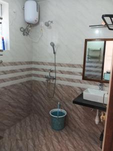 a bathroom with a shower and a sink at Plams Beach comfort in Benaulim