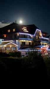 a building with lights on it at night at Donovaly Apartman Galileo in Donovaly