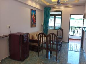 a living room with a table and chairs and a couch at Plams Beach comfort in Benaulim