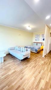 a living room with two beds and a couch at Затишна красива студія в новобудові з балконом in Chernivtsi