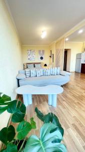 a living room with two couches and two tables at Затишна красива студія в новобудові з балконом in Chernivtsi