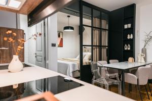 a room with a table and chairs and a bedroom at Calidum Boutique Suites in Šibenik