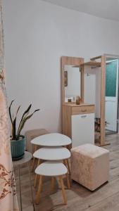 a room with a table and two chairs and a mirror at City Center Room in Tirana +3 photos