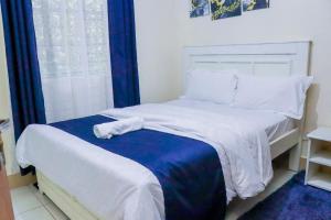 Ένα ή περισσότερα κρεβάτια σε δωμάτιο στο 2BR Elgon Hill Homes Stay in Elgon View Estate
