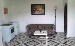 a living room with a couch and a table at 5 mins walk from Kingstown! - McKies Hill Suite #1 - Your Home Away from Home in Kingstown