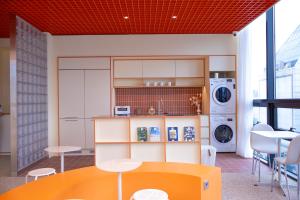 a kitchen with a table and a washer and dryer at THE EXTAY Lounge Jongno in Seoul