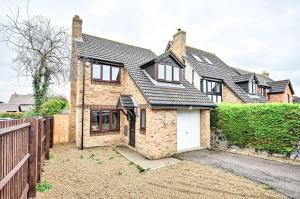 a brick house with a white garage at Quiet & Modern Contemporary Home for Work & Family in Bedford