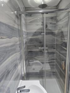 a bathroom with a shower and a sink at MJ Rooms, St Leonads on Sea, Hastings UK in Hollington