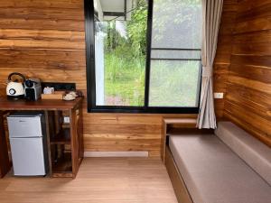 a kitchen with a desk and a window in a room at A-Na-Lay Resort Koh Kood in Ko Kood